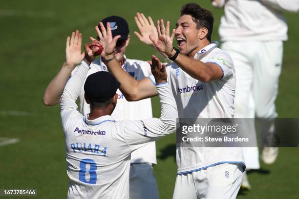 Cheteshwar Pujara of Sussex celebrates with Ari Karvelas and Jack Carson after taking the wicket of Rishi Patel of Leicestershire during the LV=...