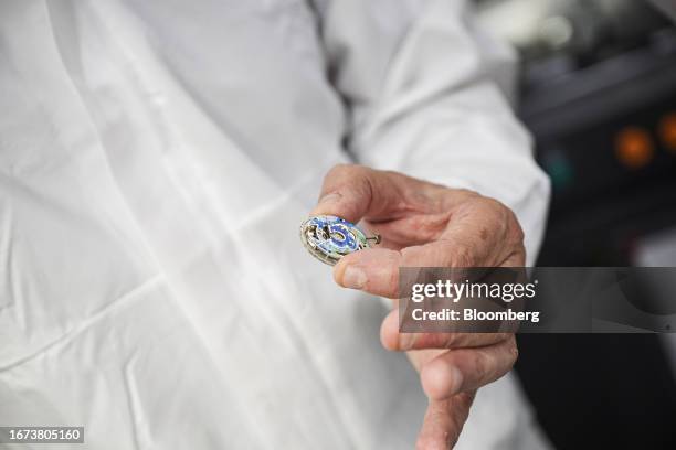 Nick Hayek, chief executive officer of Swatch Group AG, with a Sistem51 automatic movement for a Swatch x Blancpain Fifty Fathoms watch at the Swatch...