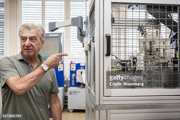 Nick Hayek, chief executive officer of Swatch Group AG, points to a machine at the Swatch Group AG ETA factory in Grenchen, Switzerland, on...