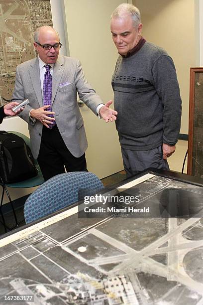 Recently retired Aviation Director Jose Abreu, left, discusses the secret CIA Headquarters at Opa-Locka Airport with historian Antolin Carbonell,...