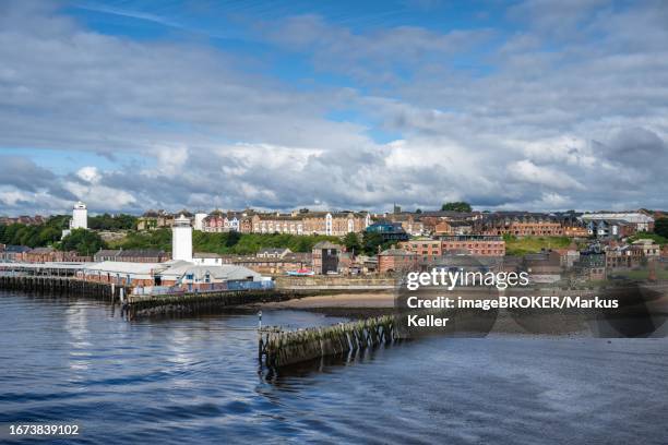 north bank of the river tyne, fish market on the left with the old low lighthouse on the right and the fish quay high lighthouse on the left, north shields, newcastle upon tyne, northumberland, england, united kingdom - north shields stock pictures, royalty-free photos & images