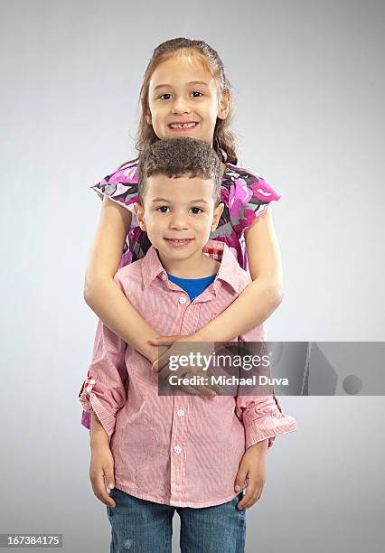 studio shot of brother and sister  gray background - michael virtue stock pictures, royalty-free photos & images