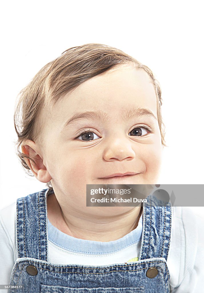 Boy on white background holding laugh back
