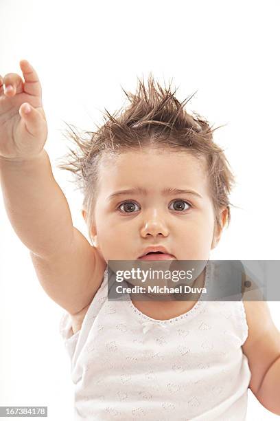 excited baby raising her hand and pointing - michael virtue stock pictures, royalty-free photos & images
