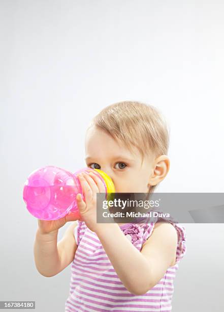 girl drinking while looking onward studio shot - beaker white background stock pictures, royalty-free photos & images