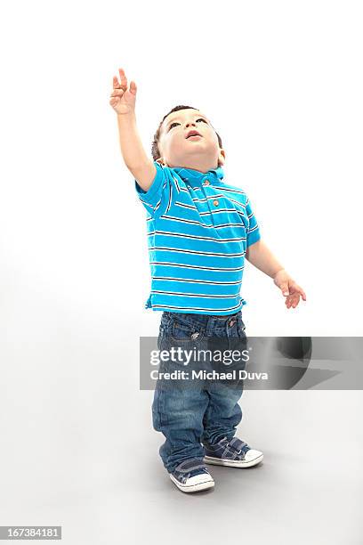 studio shot of a child excited on gray background - michael virtue stock pictures, royalty-free photos & images