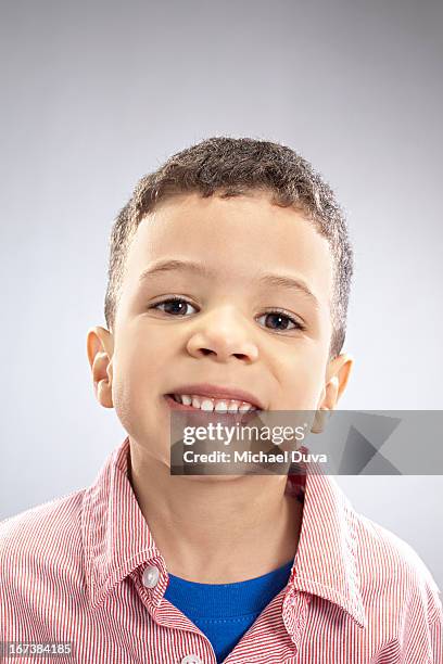 studio shot of a boy smiling on gray background - michael virtue stock pictures, royalty-free photos & images
