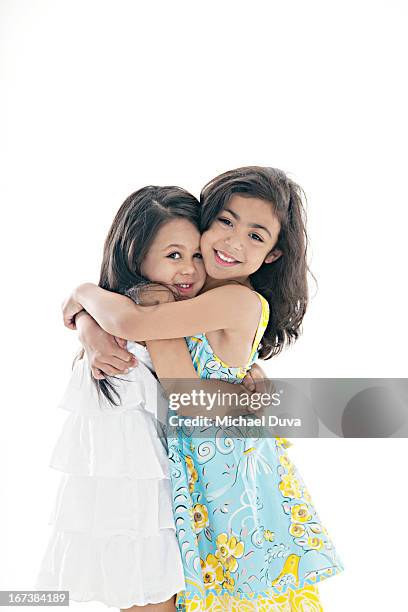 studio shot of friends hugging on gray background - michael virtue stock pictures, royalty-free photos & images