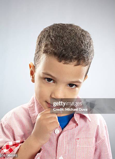 studio shot of a boy thinking gray background - michael virtue stock pictures, royalty-free photos & images