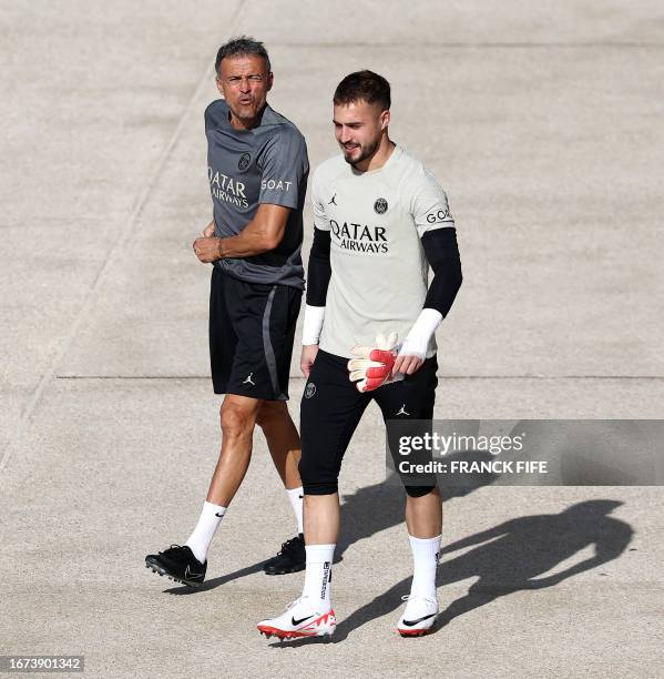 Paris Saint-Germain's Spanish head coach Luis Enrique and Paris Saint-Germain's Spanish goalkeeper Arnaud Tenas arrive for a training session at...