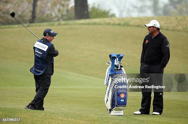 Caddie Dave Renwick shows Ricardo Gonzalez of Argentina how it should be done during the first round of the Ballantine's Championship at Blackstone...