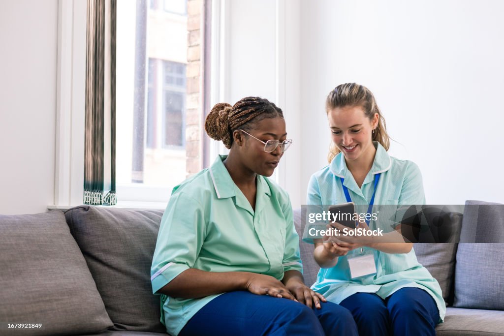 Coworkers Looking at Phone