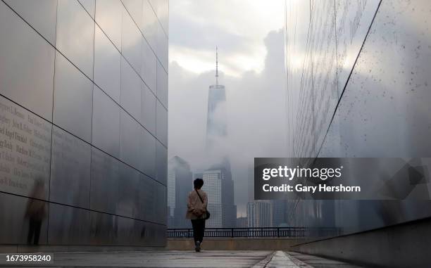 Fog shrouds the skyline of lower Manhattan and One World Trade Center as the sun rises on the 22nd anniversary of the 9/11 attacks in New York City...