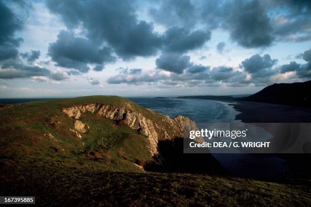 Sparse clouds over the Worm's Head, Gower Peninsula, Wales, United Kingdom.