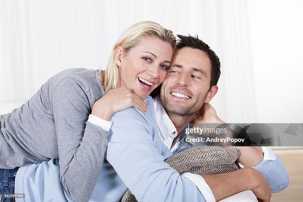 Happy man and woman cuddling