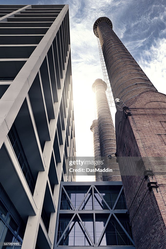 Old chimney and modern office building counterparted