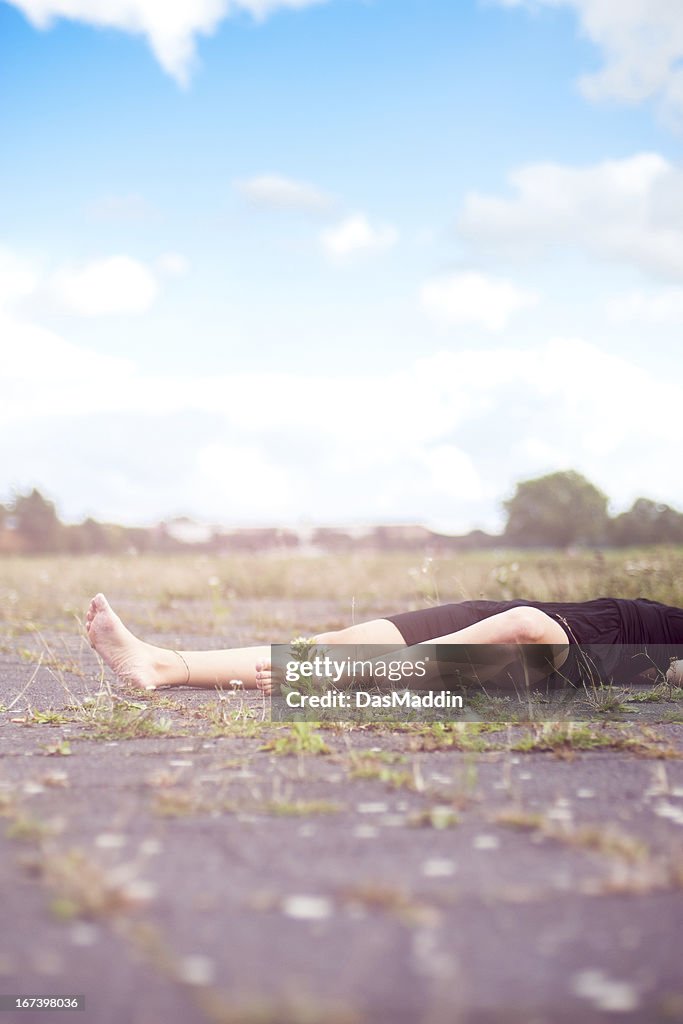 Beautiful legs of a young girl laying on the ground