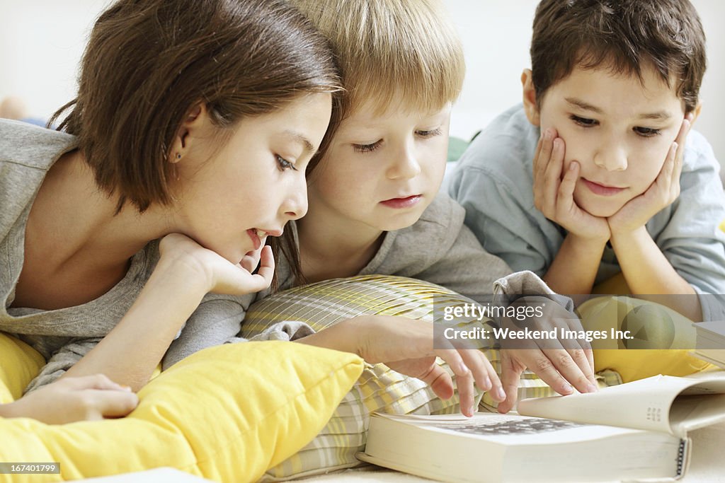 Kids reading a textbook