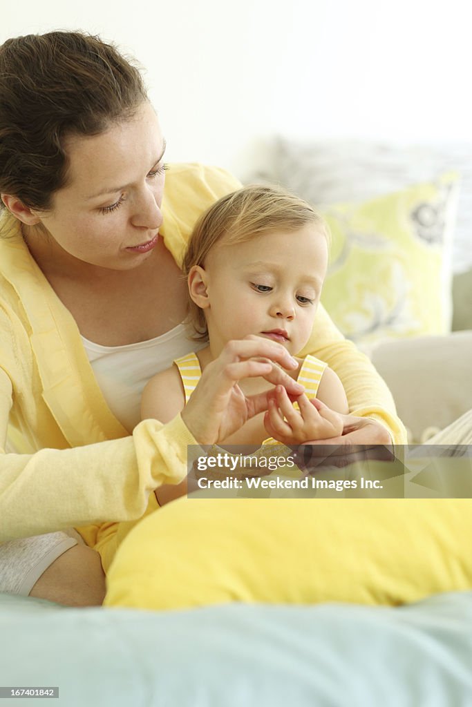 Mother and child playing with fingers