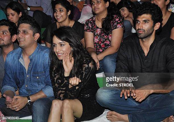Indian Bollywood personalities Mohit Suri, Shraddha Kapoor, and Aditya Roy Kapoor attend a promotional event for the Hindi film "Aashiqui 2" in...