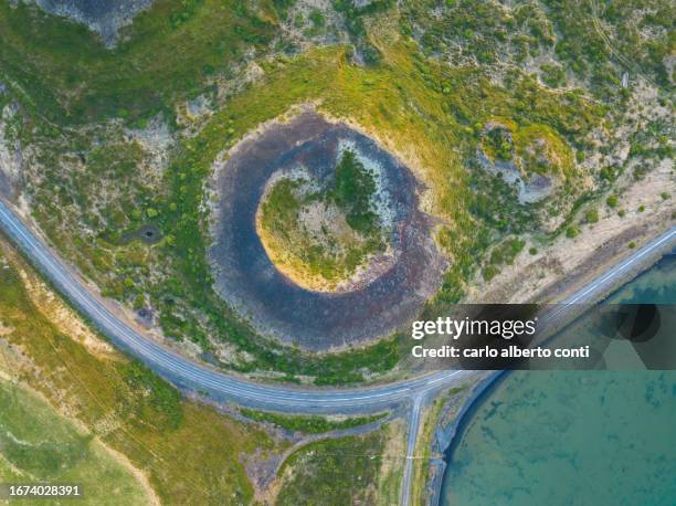 aerial vertical view of old volcano and ashpalt road, near to myvatn lake during a summer day, iceland, europe - berg mount vindbelgur stock-fotos und bilder