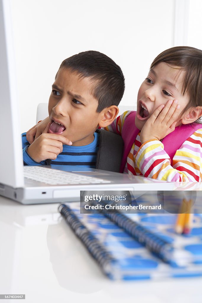 Young boy and girl researching on the internet