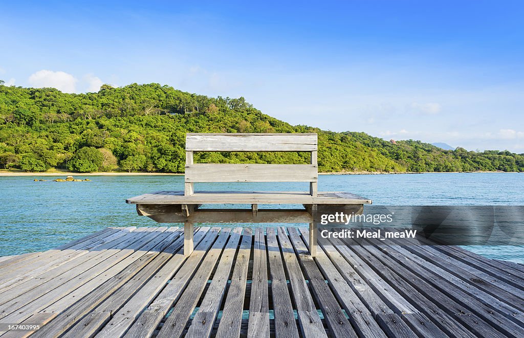 Wooden chair at pier in the sea, Thailand