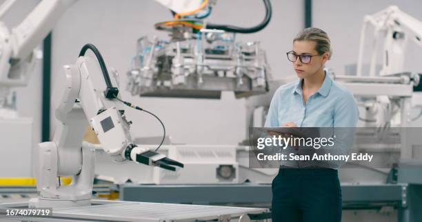 tablet, automation and manufacturing with woman in factory for robotics, futuristic and production. inspection, technology and ai software with person for engineering, industry 4.0 and electronics - bot stock pictures, royalty-free photos & images