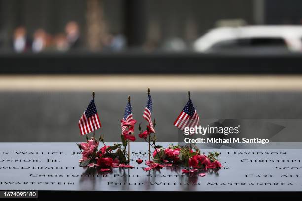 Flowers and flags are seen on the names of the victims of the 9/11 terror attack at the North Tower Memorial Pool during the annual 9/11...