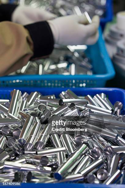 Eyeliner containers sit in plastic baskets on the production line for manufacturing cosmetics containers at the Jangup System Co. Factory in Yongin,...