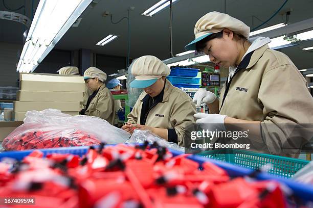 Jangup System Co. Employees work on the production line manufacturing cosmetics containers at the company's factory in Yongin, South Korea, on...