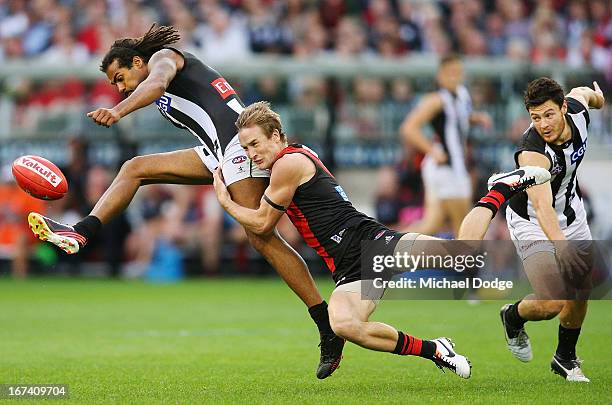 Jason Winderlich of the Bombers tackles Harry O'Brien of the Magpies during the round five AFL match between the Essendon Bombers and the Collingwood...