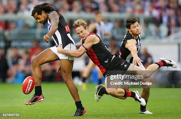 Jason Winderlich of the Bombers tackles Harry O'Brien of the Magpies during the round five AFL match between the Essendon Bombers and the Collingwood...