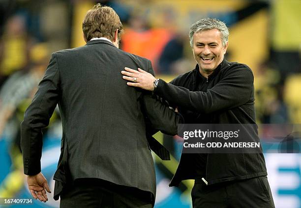 Dortmund's head coach Juergen Klopp share a joke with Real Madrid's Portuguese coach Jose Mourinho before the UEFA Champions League semi final first...