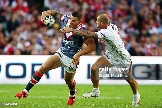 Sonny Bill Williams of the Roosters tries to pass Matt Cooper of the Dragons during the round seven NRL match between the Sydney Roosters and the St...