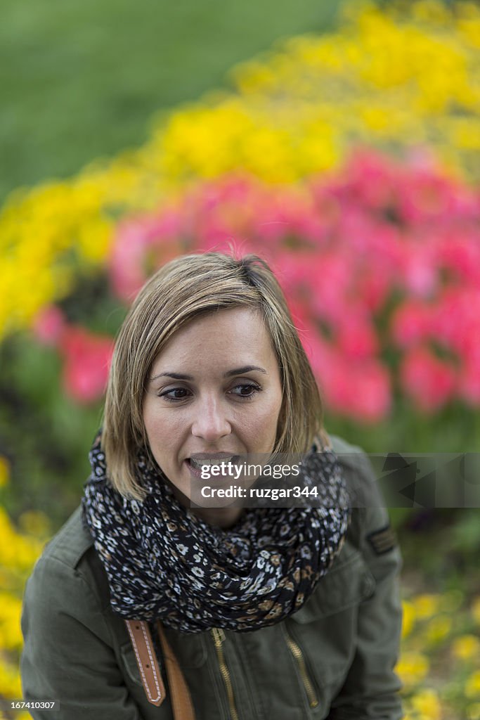 Pretty traveller woman in a colorful spring park