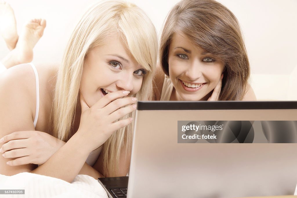 Two female friends browsing internet