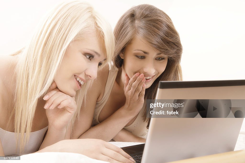 Two female friends browsing internet