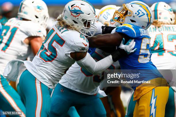 Duke Riley of the Miami Dolphins and Amen Ogbongbemiga of the Los Angeles Chargers at SoFi Stadium on September 10, 2023 in Inglewood, California.