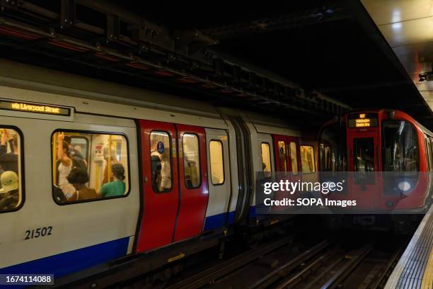 District line trains are seen entering the platform at Embankment Underground Station.