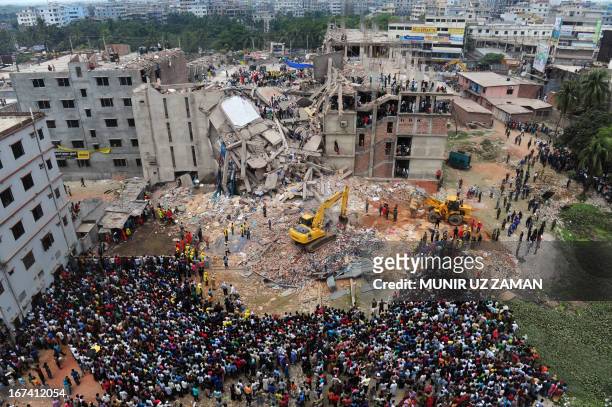 Bangladeshi volunteers and rescue workers are pictured at the scene after the Rana Plaza garment building collapsed in Savar, on the outskirts of...