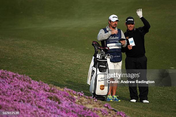 Louis Oosthuizen of South Africa stands with his caddie Wynand Stander on the tenth hole during the first round of the Ballantine's Championship at...