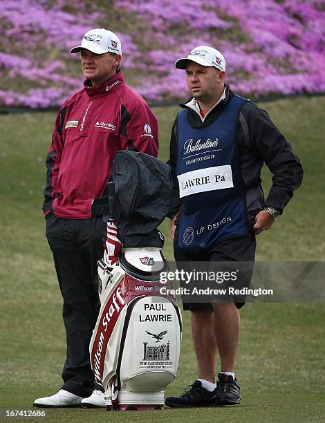 Paul Lawrie of Scotland and his caddie David Kennycduring the first round of the Ballantine's Championship at Blackstone Golf Club on April 25, 2013...