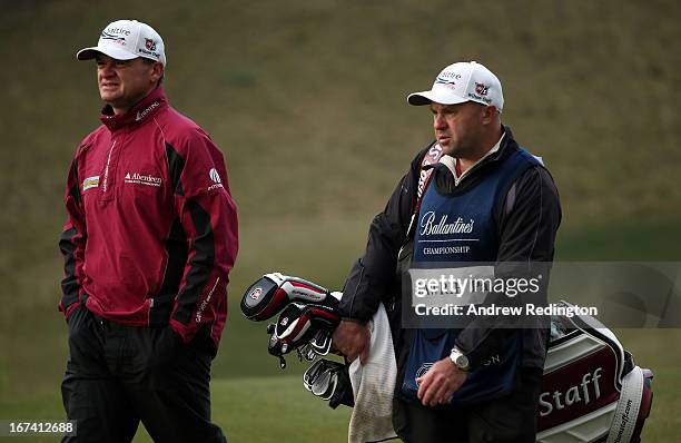 Paul Lawrie of Scotland and his caddie David Kennycduring the first round of the Ballantine's Championship at Blackstone Golf Club on April 25, 2013...