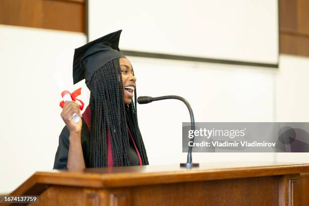 a valedictorian giving a speech during the graduation ceremony - graduation valedictorian stock pictures, royalty-free photos & images