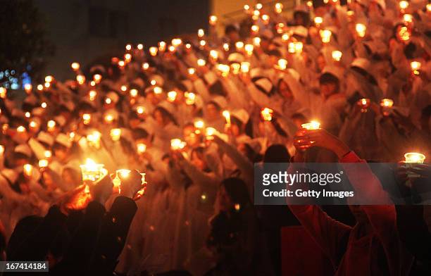 Students of University of South China light candles to pray for quake victims on April 24, 2013 in Hengnan, China. A powerful earthquake struck the...