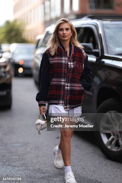 Tommy Hilfiger Fashion Brunch guest Xenia Adonts was seen wearing white socks, white prada loafer shoes, a white ribbed skirt, a black top and an...