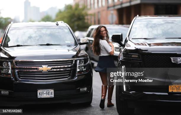 Tommy Hilfiger Fashion Brunch guest Lily Chee was seen wearing brown leather boots, a blue short skirt and a black top on September 10, 2023 in New...