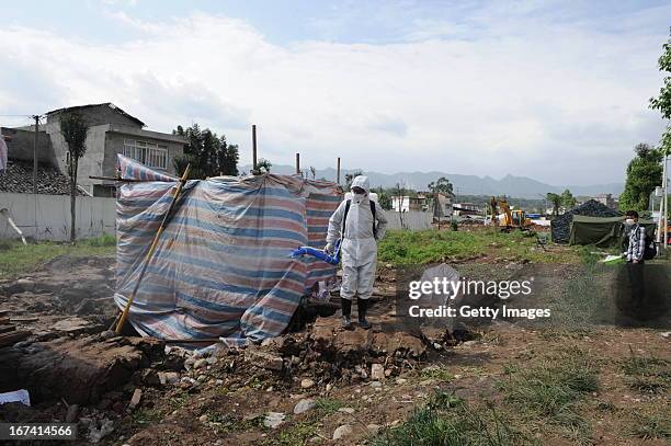 Health worker sprays disinfectant at a shelter on April 24, 2013 in Lushan County, China. A powerful earthquake struck the steep hills of China's...