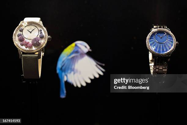 Wristwatches from Jaquet Droz's L'Heure Celeste collection, left, and Petite Heure Minute 35mm collection, sit on display at the company's booth...